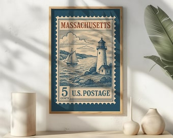 May include: A framed rectangular wall art print featuring a vintage-style postage stamp design. The illustration depicts a lighthouse on a rocky coast with a sailboat on the water. The text reads MASSACHUSETTS and 5 CENTS U.S. POSTAGE.