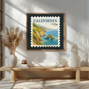 May include: Framed print of a California postage stamp featuring a coastal landscape with a rock archway. The stamp is labeled "CALIFORNIA US 15¢" and is set against a dark green background within a wooden frame. The artwork is displayed on a white wall.