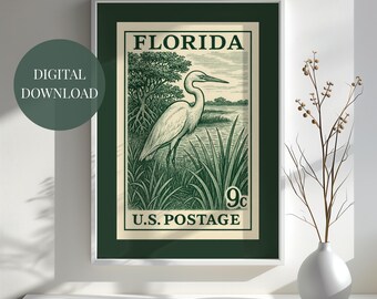 May include: A framed print of a vintage Florida postage stamp featuring a white heron standing in a marsh. The stamp is green and cream-colored, with the words "FLORIDA" and "U.S. POSTAGE" printed on it. The text "DIGITAL DOWNLOAD" is on a green circle.