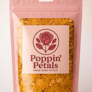 May include: A pink pouch filled with dried yellow rose petals. The pouch has a clear window displaying the petals and a label with a rose illustration and the text "Poppin' Petals Dried Rose Petals."