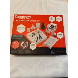 May include: A red and black Discovery Mindblown Ultimate Science Kit with 17 pieces. The kit includes beakers, a volcano model, and various experiment materials. The box features the text "Bring Home The Science" and "Hands-On Learning".