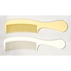 May include: Two plastic combs. One is a pale yellow color, and the other is white. Both combs have a handle and closely spaced teeth. The combs are designed for hair care and styling.