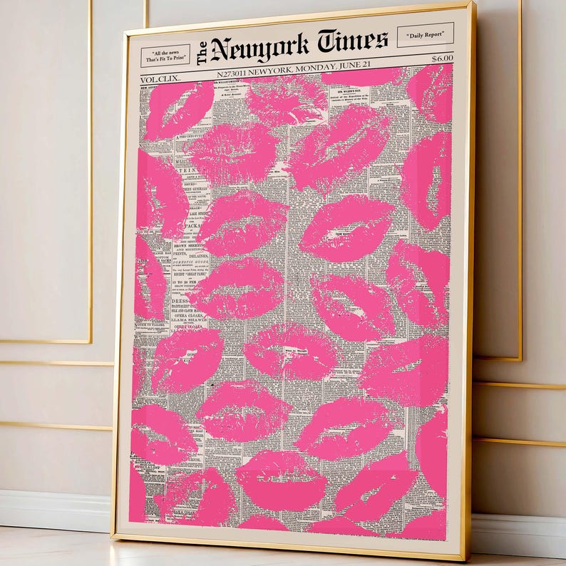 May include: A framed print featuring a collage of bright pink lipstick kiss marks over a vintage newspaper background. The print is in a gold frame and includes the text "The New York Times" at the top. A stylish and unique wall art piece.