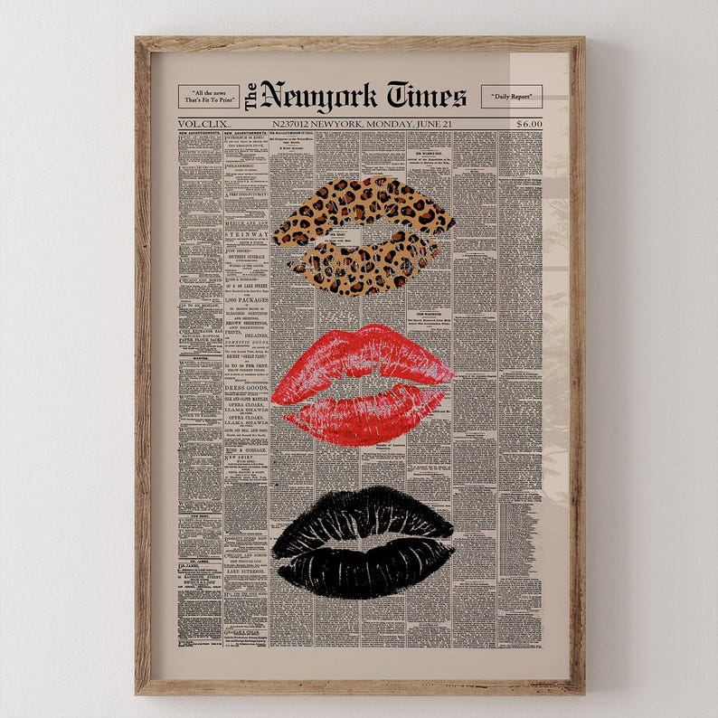 May include: Framed print featuring three sets of lips in leopard print, red, and black, set against a vintage newspaper background. The top of the print displays the text "The New York Times" and the date "Monday, June 21". The print is encased in a wooden frame.