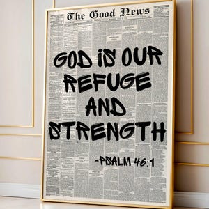 May include: A framed wall art print featuring a vintage newspaper background titled The Good News. Overlaid in bold black brush-style lettering is the text God Is Our Refuge And Strength, followed by the citation -Psalm 46:1 in a matching font.