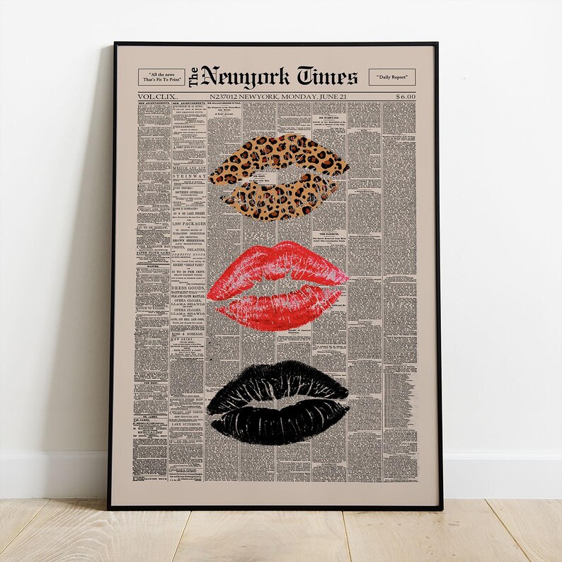 May include: A framed print featuring three sets of lips in different styles. The top lip print has a leopard print pattern, the middle lips are red, and the bottom lips are black. The background is a vintage newspaper print with the text "The New York Times".
