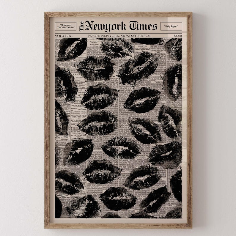 May include: A framed print featuring a collage of black lipstick kiss marks over a vintage newspaper background. The newspaper is from The New York Times, dated June 21. The print is in a wooden frame.
