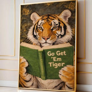May include: A framed art print features a tiger reading a green book with the text "Go Get 'Em Tiger." The tiger has orange and black stripes with a focused expression. The background has floral and foliage elements.