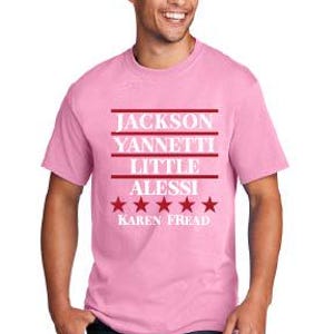 May include: A light pink t-shirt with the names "Jackson, Yannetti, Little, Alessi" in white text, separated by red lines. Below the names are five red stars and the name "Karen Fread".