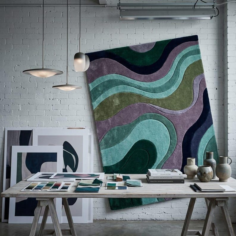 Abstract Wave Tufted Rug Hanging in Art Studio - Designer Mood Board Context - Retro Abstract Rug - Artistic Area Rug - Handmade Bold Statement Rug