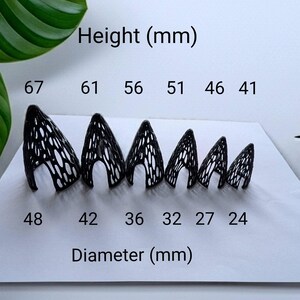 May include: A series of six black, cone-shaped objects with a lattice design, arranged in descending size. The height ranges from 67 mm to 41 mm, and the diameter from 48 mm to 24 mm. Text indicates 'Height (mm)' and 'Diameter (mm)'.