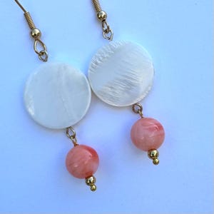 earrings white and coral mother-of-pearl and coral with gold drop dangle earrings.