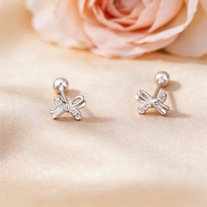 Charming Adorable Sleep-Friendly S999 Silver Hollow Bow Stud Earrings with Micro Pave CZ, Secure Screw Back Gift for Her Daily Wear.