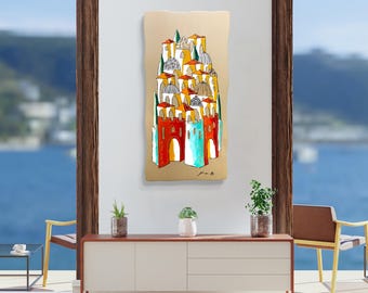 May include: An abstract painting of a cluster of buildings with red, orange, yellow, and blue facades, topped with white and brown domes. The artwork is mounted on a beige background and is displayed on a white wall. The painting is framed by a wooden window.