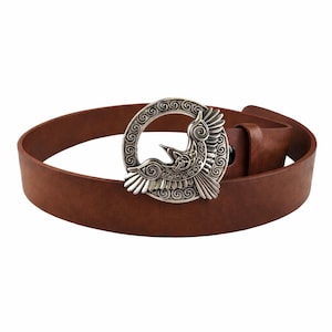 May include: A brown leather belt with a silver-colored buckle. The buckle features a detailed design of a bird within a circular frame. The belt is a medium brown color and appears to be made of genuine leather.