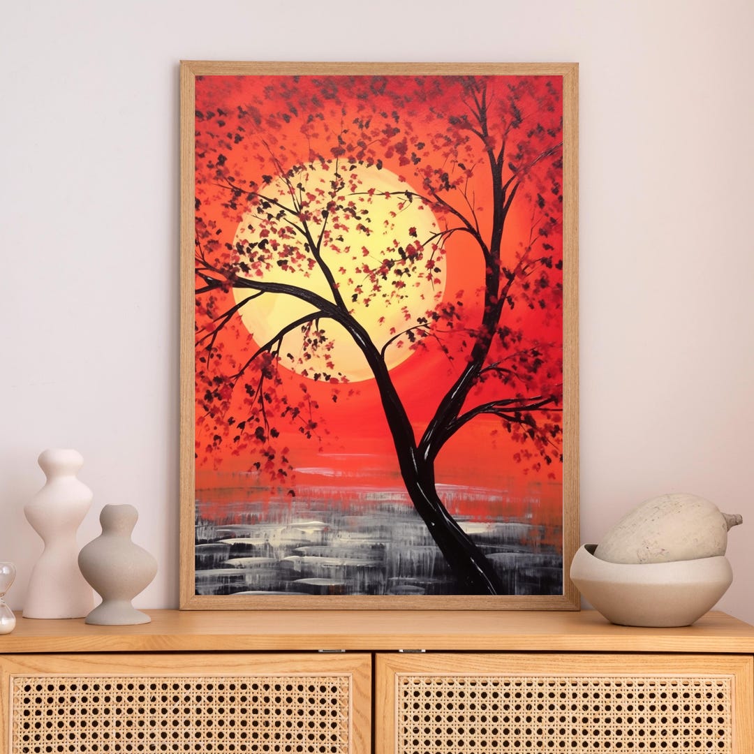 Red Sunset Tree Wall Art: a large golden sun behind a tree with black branches and red leaves, over a red-orange sky and reflective water.