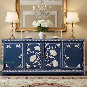 May include: A navy blue cabinet with white floral patterns and gold handles. The room features a gold mirror, lamps, and a patterned rug. The setting is a dining room with a classic, elegant design. The cabinet is approximately 150 cm wide.