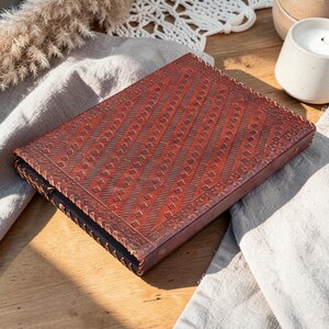 Back side of leather pentagram binder, plain vintage leather texture and stitching detail
