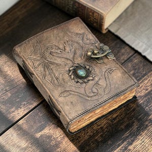Double dragon leather journal on wooden desk lifestyle setup premium handmade notebook