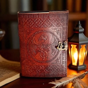 "Rustic red leather journal with dragon symbol cover"