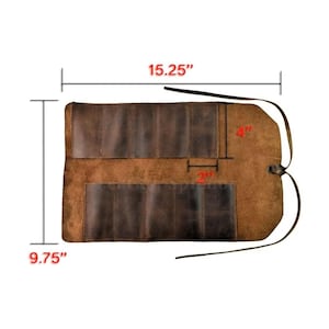 May include: A brown leather watch roll, measuring 15.25 inches long, 9.75 inches wide, and 4 inches high when rolled. The interior features multiple compartments, each 2 inches wide, designed to hold watches. A leather strap secures the roll.
