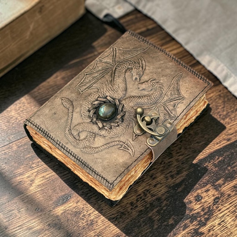 Three side angle view double dragon leather journal showing thickness spine and edges