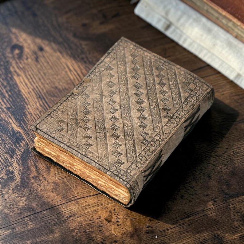 Angled back side view leather journal showing stitching and texture detail