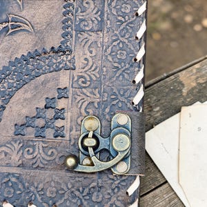 Dragon embossed leather ring binder journal A4 size, mystical fantasy aesthetic with rustic wood and parchment backdrop