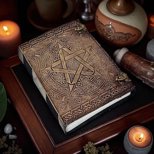 "Vintage leather grimoire journal with pagan star design"