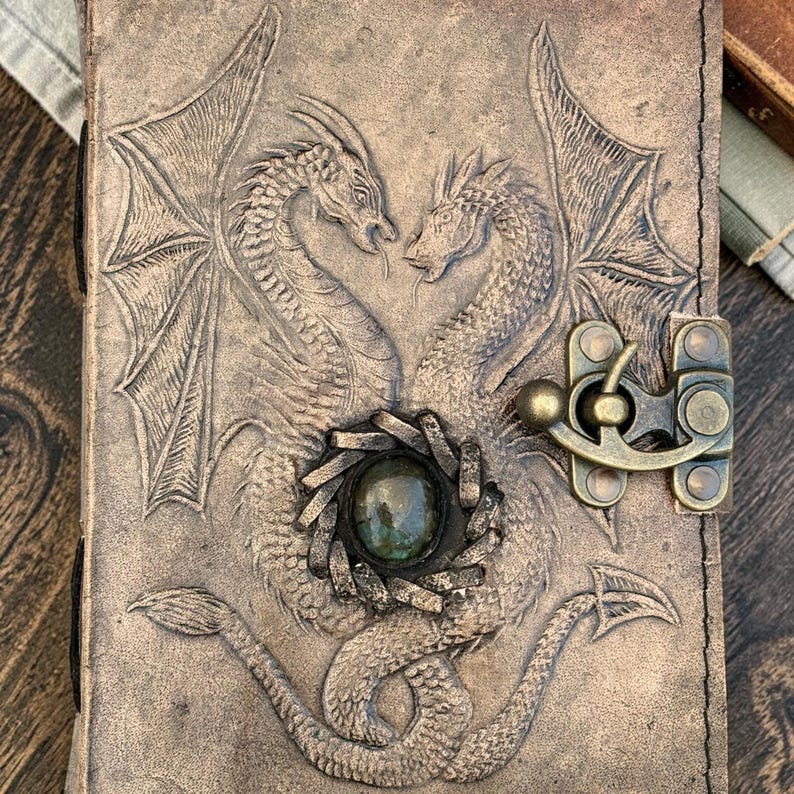 Close up of double dragon embossed leather journal showing detailed craftsmanship texture