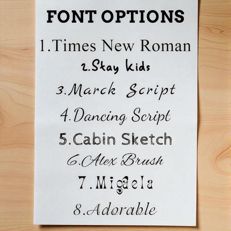 Puede incluir: Un papel blanco con el texto "FONT OPTIONS" en negrita negra. Debajo, se enumeran ocho opciones de fuente: Times New Roman, Stay kids, Marck Script, Dancing Script, Cabin Sketch, Alex Brush, Migaela y Adorable.
