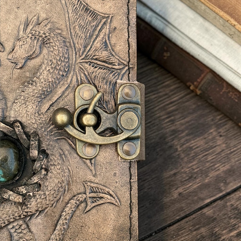 Close up of metal lock clasp on double dragon leather journal secure closure detail