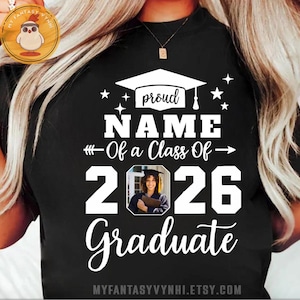 May include: Black t-shirt with a graduation design. The design includes the word "proud", a graduation cap, stars, the text "NAME Of a Class Of 2026 Graduate", and a photo. The Etsy shop URL is at the bottom.