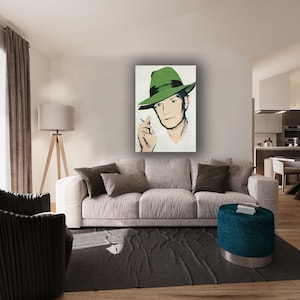 May include: A rectangular wall art print featuring a stylised illustration of a person wearing a green fedora hat with a dark band. The person is depicted with a light complexion, dark hair, and is holding a small object near their face.