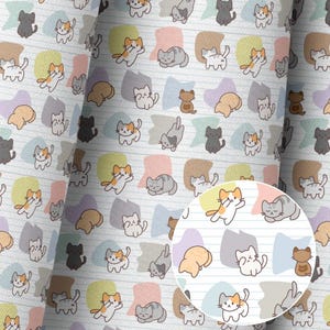 May include: White fabric with a repeating pattern of cartoon cats in various poses. The cats are in shades of gray, orange, brown, and black, set against colorful pastel shapes. The background has light blue lines.