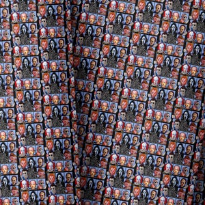 May include: Fabric with a repeating pattern of horror movie characters and the text "The Psycho Bunch". The design includes images of the Scream mask, Pennywise, and other figures on a black background.