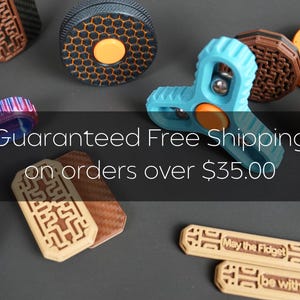 May include: A collection of colorful fidget toys in various shapes and designs, including spinners and bars. The image includes the text "Guaranteed Free Shipping on orders over $35.00". The fidgets are in shades of blue, orange, brown, and green.