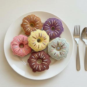 Puede incluir: Un juego de tres tazas de cerámica con un acabado moteado y mate. Las tazas son de color crema, gris claro y gris oscuro. Cada taza tiene un diseño simple y minimalista, ideal para café o té.