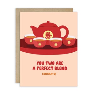 May include: Greeting card with a red teapot and four matching teacups on a red tray. The teapot and cups have a Chinese double happiness symbol. The card reads "YOU TWO ARE A PERFECT BLEND CONGRATS!"