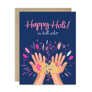 May include: Greeting card with a navy blue background and the text "Happy Holi!" in pink script. The card features an illustration of two hands with colorful powder, with the words "in full color" below the main text.