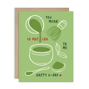 May include: A green greeting card with a matcha theme. The card features white line drawings of matcha preparation tools and the words "You Mean So Matcha To Me" and "Happy V-Day" in red and black.