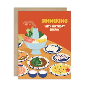 May include: Greeting card with an illustration of a hot pot with various ingredients and side dishes. The card has the text "Simmering with Birthday Energy" in yellow letters on an orange background. The card is on a brown envelope.