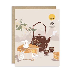 May include: Greeting card with a Mid-Autumn Festival illustration. The design features a brown teapot, mooncakes, teacups, and white rabbits. The card has a beige background with a yellow sun and Chinese characters.