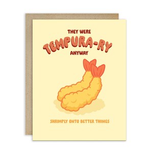 May include: A greeting card with a tan background and a brown border. The card features two cartoon tempura shrimp with the text "THEY WERE TEMPURA-RY ANYWAY" and "SHRIMPLY ONTO BETTER THINGS" in orange and brown.