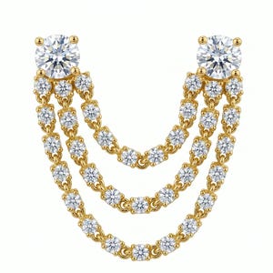 May include: A gold earring connector featuring two larger round-cut clear stones at the top, from which three draped chains of smaller round-cut clear stones hang in a cascading U-shape, creating a layered, articulated design with a polished finish.