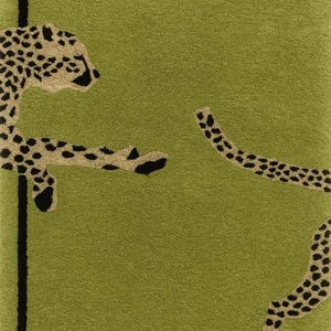 May include: Green rectangular rug with a black border and a cheetah design. The cheetah has tan fur with black spots. The rug is a soft, plush material.