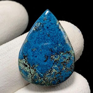 May include: A teardrop-shaped gemstone with a vibrant blue hue, accented by intricate patterns of black and green. The polished surface reflects light, showcasing the stone's natural beauty. This gemstone is a unique piece for jewelry making or collecting.