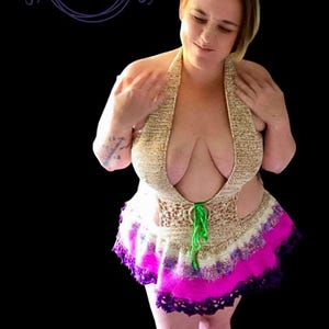 May include: A handmade halter top and skirt set. The top is beige with a deep neckline, and the skirt features a vibrant pink and purple trim. The set is tied with a green cord. The image includes the text "Stitches & Fables" in a circular logo.