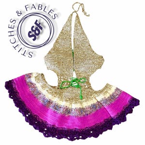 May include: A handmade crochet halter top and skirt set. The top is gold with a halter neck tie. The skirt features a vibrant gradient of colours, including purple, pink, and cream. The set is adorned with a green tie at the waist and a scalloped edge.