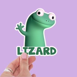 May include: A green cartoon lizard sticker with the word "LIZARD" in white block letters. The lizard is smiling and waving, with large, round eyes. The background is a solid lilac colour.